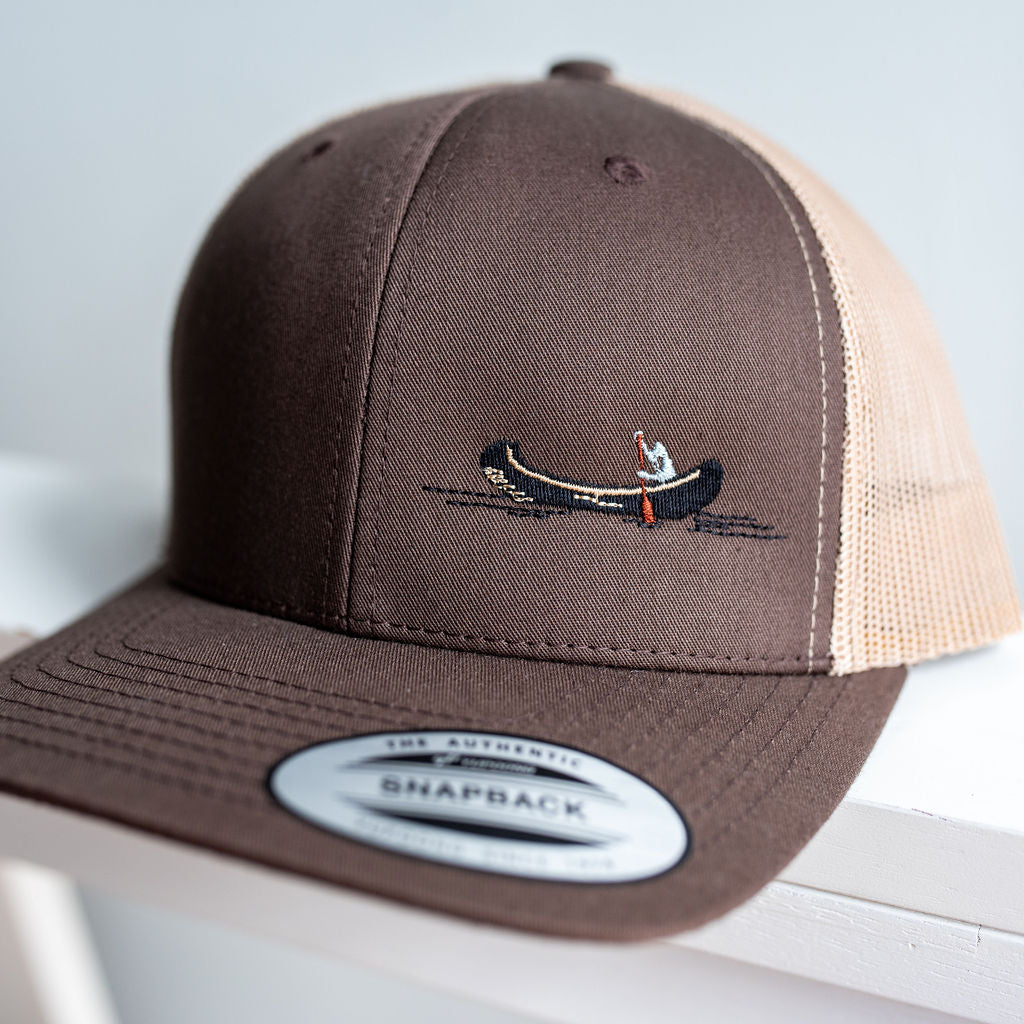 Snap-back cap with embroidered canoe motif